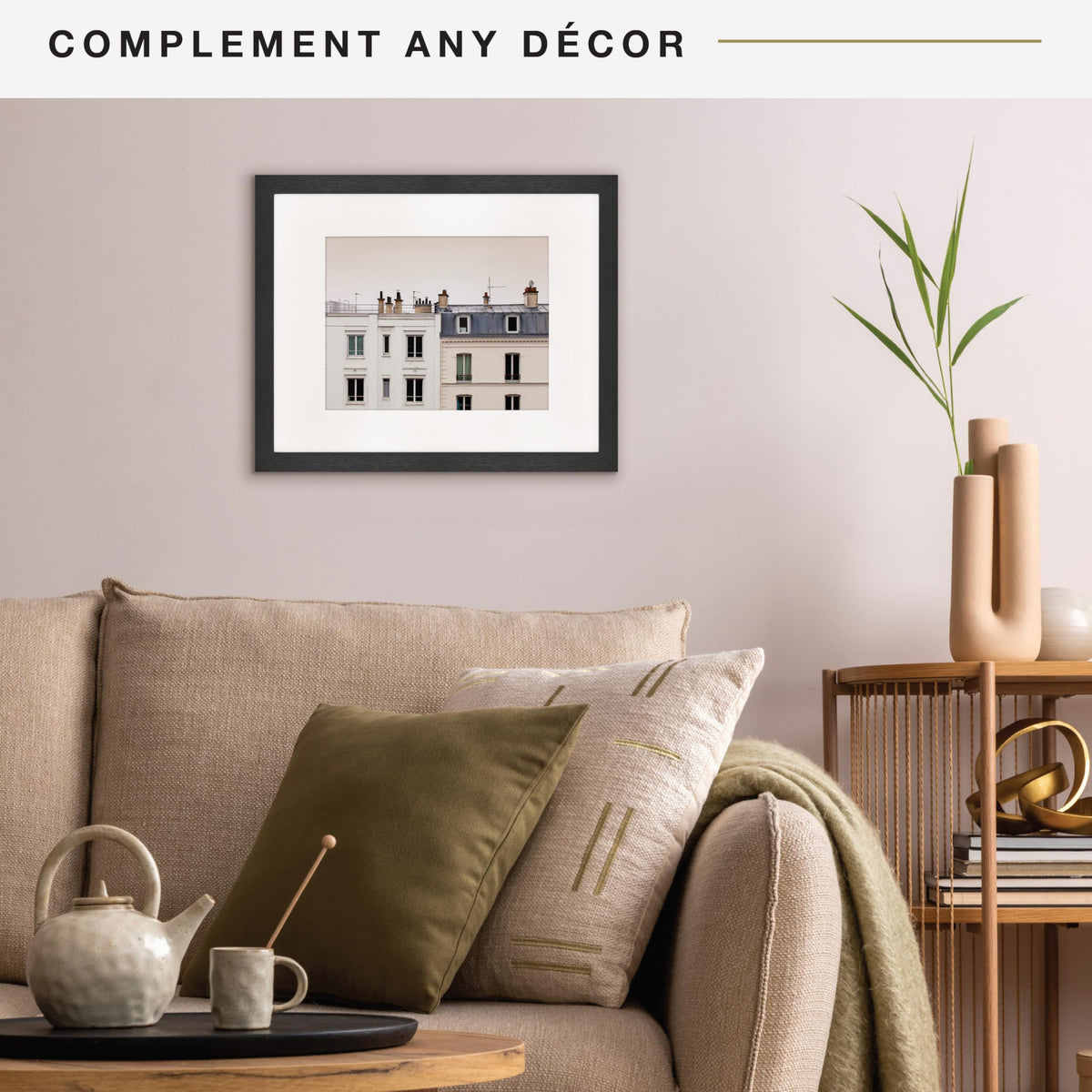Living room with beige sofa, framed artwork, and decorative items.